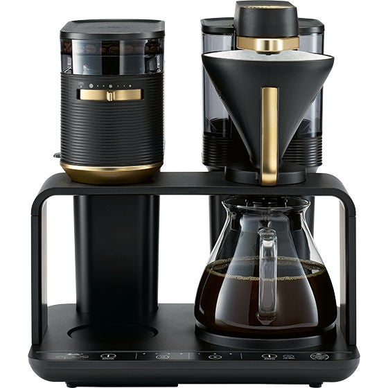 Melitta® epos Filter Coffee Maker 6776227 – front view product shot with gold elements and coffee jug